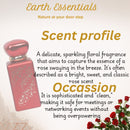 Pink perfume bottle with text about 'Earth Essentials' rose fragrance