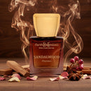 Earth Essentials Sandalwood Playtime perfume bottle with cinnamon sticks, berries, and smoke on a wooden surface.