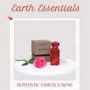Red perfume bottle and box with a pink rose on a white surface, branded 'Earth Essentials'.